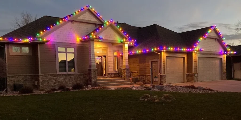 Home adorned with colorful holiday lighting, showcasing professional installation for seasonal decorations, enhancing charm and security.