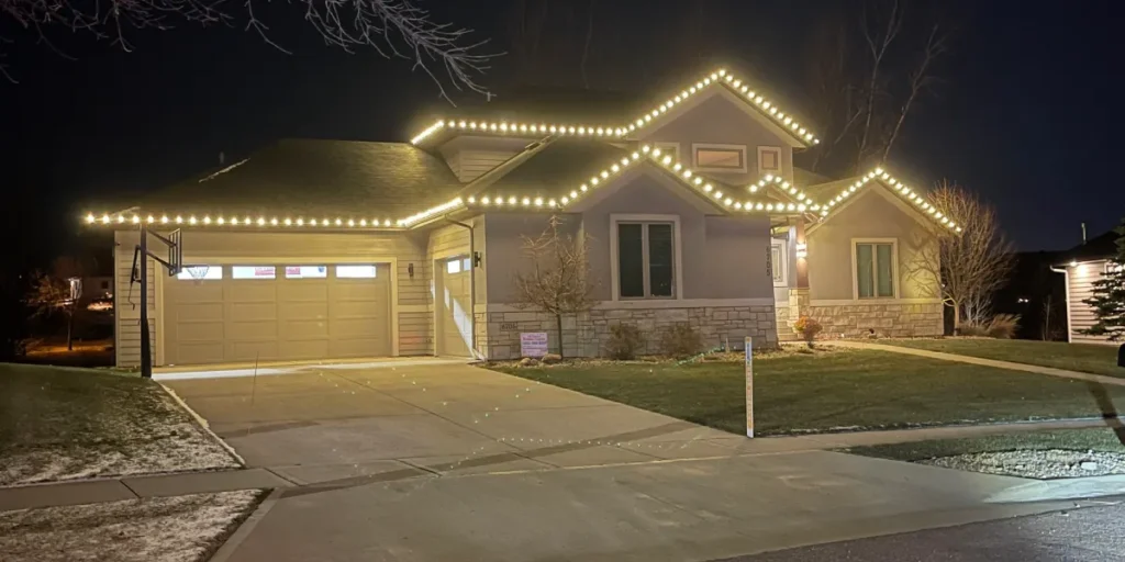 Home adorned with custom holiday lighting, showcasing a festive atmosphere and enhancing curb appeal during nighttime.